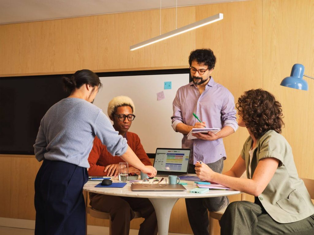 A diverse group of professionals collaborating over a glowing digital interface